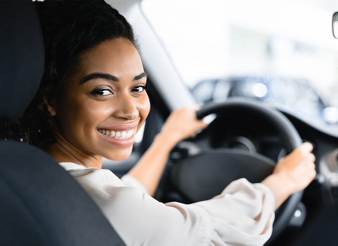 Livery Insurance - Close-up Portrait of a Woman Driver of a Car Service Smiling at the Camera