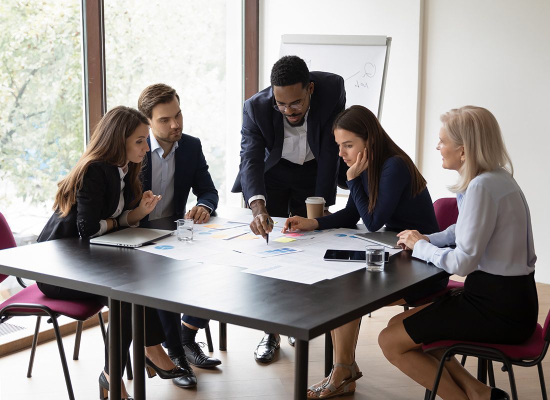 About Our Agency - Group of Business Professionals Having a Planning Meeting at an Office